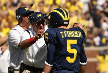 ANN ARBOR, MI - SEPTEMBER 19:  Head coach Rich Rodriguez of the Michigan Wolverines talks with quarterback Tate Forcier #5 during the game with the Eastern Michigan Eagles at Michigan Stadium on September 19, 2009 in Ann Arbor, Michigan.  Michigan won 45-17.  (Photo by Stephen Dunn/Getty Images)