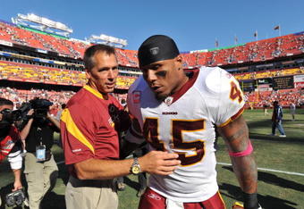 LANDOVER, MD - OCTOBER 4:  Head coach Jim Zorn walks off the field with Mike Sellers #45 of the Washington Redskins after the game against the Tampa Bay Buccaneers at FedExField on October 4, 2009 in Landover, Maryland. The Redskins defeated the Buccaneers 16-13. (Photo by Larry French/Getty Images)