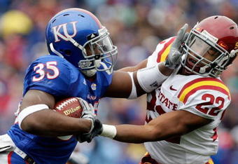 LAWRENCE, KS - OCTOBER 10:  Running back Toben Opurum #35 of the Kansas Jayhawks stiffarms Ter'ran Benton #22 of the Iowa State Cyclones during the game on October 10, 2009 at Memorial Stadium in Lawrence, Kansas.  (Photo by Jamie Squire/Getty Images)