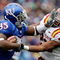LAWRENCE, KS - OCTOBER 10:  Running back Toben Opurum #35 of the Kansas Jayhawks stiffarms Ter'ran Benton #22 of the Iowa State Cyclones during the game on October 10, 2009 at Memorial Stadium in Lawrence, Kansas.  (Photo by Jamie Squire/Getty Images)