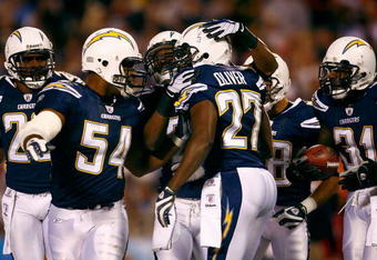 SAN DIEGO - DECEMBER 28:  (L-R) Stephen Cooper #54, Antoine Cason #20 and Antonio Cromartie #31 of the San Diego Chargers congratulate teammate Paul Oliver #27 after Oliver intercepted a pass against the Denver Broncos during the second quarter of the NFL game at Qualcomm Stadium on December 28, 2008 in San Diego, California. The Chargers defeated the Broncos 52--21. (Photo by Jeff Gross/Getty Images)