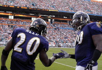 MIAMI, FL - JANUARY 4:  Safety Ed Reed #20 of the Baltimore Ravens celebrates an interception with defensive tackle Trevor Price #90  against the Miami Dolphins in an NFL Wildcard Playoff Game at Dolphins Stadium on January 4, 2009 in Miami, Floirda.  Reed ran for a touchdown with the interception. (Photo by Al Messerschmidt/Getty Images) 