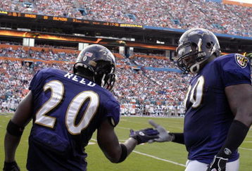 MIAMI, FL - JANUARY 4:  Safety Ed Reed #20 of the Baltimore Ravens celebrates an interception with defensive tackle Trevor Price #90  against the Miami Dolphins in an NFL Wildcard Playoff Game at Dolphins Stadium on January 4, 2009 in Miami, Floirda.  Reed ran for a touchdown with the interception. (Photo by Al Messerschmidt/Getty Images) 