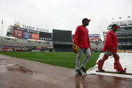 NEW YORK - OCTOBER 15: Darren Oliver #38 and coach Steve Soliz #61 of the Los Angeles Angels of Anaheim walk past the tarp covering the field during workouts on October 15, 2009 at Yankee Stadium in the Bronx borough of New York City. (Photo by Jared Wickerham/Getty Images)