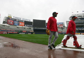NEW YORK - OCTOBER 15: Darren Oliver #38 and coach Steve Soliz #61 of the Los Angeles Angels of Anaheim walk past the tarp covering the field during workouts on October 15, 2009 at Yankee Stadium in the Bronx borough of New York City.  (Photo by Jared Wickerham/Getty Images)