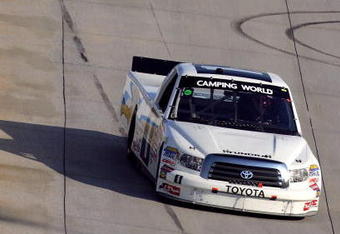 DOVER, DE - MAY 30:  Johnny Benson, driver of the #1 Red Horse Racing Toyota, races Kyle Busch, driver of the #51 Miccosukee Resort Toyota, during the NASCAR Camping World Truck Series AAA Insurance 200 at Dover International Speedway on May 30, 2009 in Dover, Delaware.  (Photo by Chris Trotman/Getty Images)