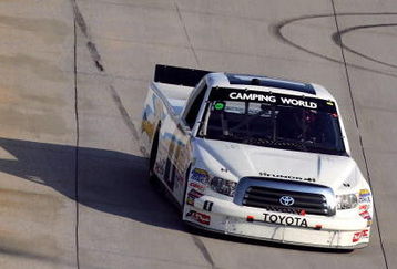 DOVER, DE - MAY 30:  Johnny Benson, driver of the #1 Red Horse Racing Toyota, races Kyle Busch, driver of the #51 Miccosukee Resort Toyota, during the NASCAR Camping World Truck Series AAA Insurance 200 at Dover International Speedway on May 30, 2009 in Dover, Delaware.  (Photo by Chris Trotman/Getty Images)