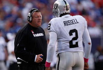EAST RUTHERFORD, NJ - OCTOBER 11:  Head Coach Tom Cable and JaMarcus Russell #2 of the Oakland Raiders talk in between plays during the game on October 11, 2009 at Giants Stadium in East Rutherford, New Jersey.  (Photo by Jared Wickerham/Getty Images)