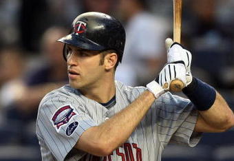 NEW YORK - OCTOBER 09:  Joe Mauer #7 of the Minnesota Twins bats against the New York Yankees in Game Two of the ALDS during the 2009 MLB Playoffs at Yankee Stadium on October 9, 2009 in the Bronx borough of New York City.  (Photo by Jim McIsaac/Getty Images)