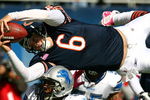 CHICAGO - OCTOBER 04: Jay Cutler #6 of the Chicago Bears leaps over Julian Peterson #59 of the Detroit Lions to score a touchdown in the first quarter on October 4, 2009 at Soldier Field in Chicago, Illinois.  (Photo by Jonathan Daniel/Getty Images)
