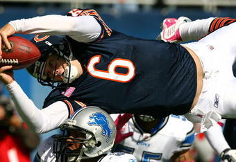 CHICAGO - OCTOBER 04: Jay Cutler #6 of the Chicago Bears leaps over Julian Peterson #59 of the Detroit Lions to score a touchdown in the first quarter on October 4, 2009 at Soldier Field in Chicago, Illinois.  (Photo by Jonathan Daniel/Getty Images)