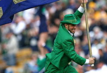 SOUTH BEND, IN - OCTOBER 03: The leprechaun mascot for the Notre Dame Fighting Irish runs onto the field with a flag before a game against the Washington Huskies on October 3, 2009 at Notre Dame Stadium in South Bend, Indiana. Notre Dame defeated Washington 37-30 in overtime. (Photo by Jonathan Daniel/Getty Images)