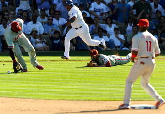 LOS ANGELES, CA - OCTOBER 16:  Ronnie Belliard #3 of the Los Angeles Dodgers bunts the ball for a single as Chan Ho Park #61 of the Philadelphia Phillies dives for the ball during Game Two of the NLCS during the 2009 MLB Playoffs at Dodger Stadium on October 16, 2009 in Los Angeles, California.  (Photo by Kevork Djansezian/Getty Images)