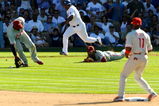 LOS ANGELES, CA - OCTOBER 16:  Ronnie Belliard #3 of the Los Angeles Dodgers bunts the ball for a single as Chan Ho Park #61 of the Philadelphia Phillies dives for the ball during Game Two of the NLCS during the 2009 MLB Playoffs at Dodger Stadium on October 16, 2009 in Los Angeles, California.  (Photo by Kevork Djansezian/Getty Images)