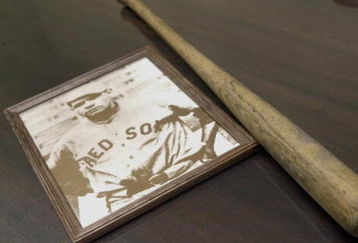 393274 05: A vintage photo and practice bat belonging to legendary ballplayer Herman 'Babe' Ruth sit on a table August 15, 2001 during a press conference to announce a public initiative to honor Ruth in Boston, MA. Ruth led the 1918 Red Sox to a World Series, but was traded the following year to the rival New York Yankees. Since then the Red Sox have gone 82 seasons without another championship. The drought has become known locally as the 'Curse of the Bambino.' The public initiative to honor Ruth is also designed to lift the curse. Red Sox management have never honored Ruth and will not participate in the September ceremony. (Photo by Darren McCollester/Getty Images)