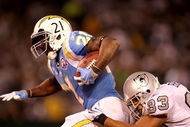 OAKLAND, CA - SEPTEMBER 14: LaDainian Tomlinson #21 of the San Diego Chargers is tackled by Tyvon Branch #33 of the Oakland Raiders during their game on September 14, 2009 at the Oakland-Alameda County Coliseum in Oakland, California. (Photo by Ezra Shaw/Getty Images)