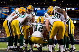 ST. LOUIS, MO - SEPTEMBER 27:  Aaron Rodgers #12 of the Green Bay Packers huddles with the offense during the game against the St. Louis Rams at the Edward Jones Dome on September 27, 2009 in St. Louis, Missouri.  (Photo by Dilip Vishwanat/Getty Images)