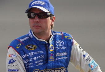 FONTANA, CA - OCTOBER 09:  David Reutimann, driver of the #00 Aaron's Dream Machine Toyota sits on pit wall during qualifying for the NASCAR Sprint Cup Series Pepsi 500 at Auto Club Speedway on October 9, 2009 in Fontana, California.  (Photo by Jason Smith/Getty Images)