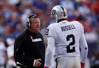 EAST RUTHERFORD, NJ - OCTOBER 11:  Head Coach Tom Cable and JaMarcus Russell #2 of the Oakland Raiders talk in between plays during the game on October 11, 2009 at Giants Stadium in East Rutherford, New Jersey.  (Photo by Jared Wickerham/Getty Images)