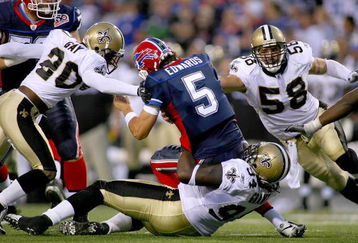 ORCHARD PARK, NY - SEPTEMBER 27: Randal Gay #24, Charles Grant #94 and Scott Shanlee #58  of the New Orleans Saints combine to sack Trent Edwards #5 of the Buffalo Bills  at Ralph Wilson Stadium on September 27, 2009 in Orchard Park, New York.  The Saints won 27-7.(Photo by Rick Stewart/Getty Images)