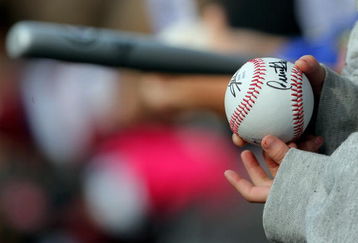 DENVER - APRIL 11:  Fans look to get autographs from the players on balls and bats as the Philadelphia Phillies face the Colorado Rockies during MLB action at Coors Field on April 11, 2009 in Denver, Colorado. The Phillies defeated the Rockies 8-4.  (Photo by Doug Pensinger/Getty Images)