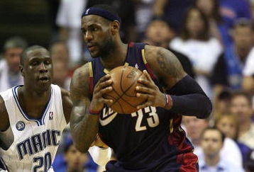 ORLANDO, FL - MAY 30:  LeBron James #23 of the Cleveland Cavaliers handles the ball against Mickael Pietrus #20 of the Orlando Magic in Game Six of the Eastern Conference Finals during the 2009 Playoffs at Amway Arena on May 30, 2009 in Orlando, Florida. NOTE TO USER: User expressly acknowledges and agrees that, by downloading and or using this photograph, User is consenting to the terms and conditions of the Getty Images License Agreement  (Photo by Elsa/Getty Images)