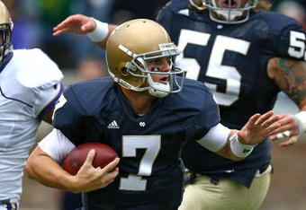 SOUTH BEND, IN - OCTOBER 03: Jimmy Clausen #7 of the Notre Dame Fighting Irish tries to avoid a tackler against the Washington Huskies on October 3, 2009 at Notre Dame Stadium in South Bend, Indiana. Notre Dame defeated Washington 37-30 in overtime. (Photo by Jonathan Daniel/Getty Images)