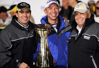 CONCORD, NC - OCTOBER 17:  (L-R) Jimmie Johnson, driver of the #48 Lowe's Chevrolet, celebrates with his crew chief Chad Knaus and team owner Rick Hendrick after winning the NASCAR Sprint Cup Series NASCAR Banking 500 at Lowe's Motor Speedway on October 17, 2009 in Concord, North Carolina.  (Photo by Rusty Jarrett/Getty Images for NASCAR)
