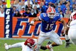 GAINESVILLE, FL - OCTOBER 17: Quarterback Tim Tebow #15 of the Florida Gators rushes upfield against the University of Arkansas Razorbacks October 17, 2009 at Ben Hill Griffin Stadium in Gainesville, Florida.  (Photo by Al Messerschmidt/Getty Images)