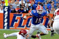 GAINESVILLE, FL - OCTOBER 17: Quarterback Tim Tebow #15 of the Florida Gators rushes upfield against the University of Arkansas Razorbacks October 17, 2009 at Ben Hill Griffin Stadium in Gainesville, Florida.  (Photo by Al Messerschmidt/Getty Images)