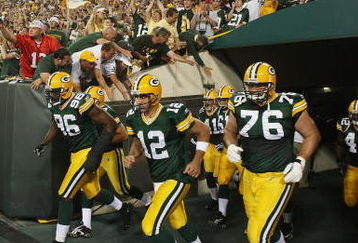 GREEN BAY, WI - SEPTEMBER 13: (L-R) Michael Montgomery #96, Aaron Rodgers #12 and Chad Clifton #76 of the Green Bay Packers run onto the field during player introductions before a game against the Chicago Bears on September 13, 2009 at Lambeau Field in Green Bay, Wisconsin. (Photo by Jonathan Daniel/Getty Images)