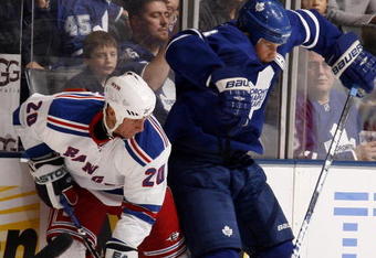 TORONTO - OCTOBER 17:  Mike Komisarek #8 of the Toronto Maple Leafs runs into Vaclav Prospal #20 of the New York Rangers during a NHL game at the Air Canada Centre on October 17, 2009 in Toronto, Ontario, Canada .  (Photo by Abelimages/Getty Images)
