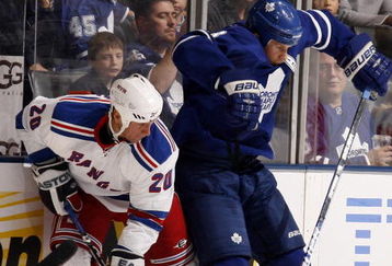 TORONTO - OCTOBER 17:  Mike Komisarek #8 of the Toronto Maple Leafs runs into Vaclav Prospal #20 of the New York Rangers during a NHL game at the Air Canada Centre on October 17, 2009 in Toronto, Ontario, Canada .  (Photo by Abelimages/Getty Images)