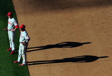 LOS ANGELES, CA - OCTOBER 16:  Chase Utley #26 and Ryan Howard #6 of the Philadelphia Phillies look on in Game Two of the NLCS during the 2009 MLB Playoffs against the Los Angeles Dodgers at Dodger Stadium on October 16, 2009 in Los Angeles, California.  (Photo by Jacob de Golish/Getty Images)