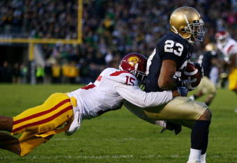 SOUTH BEND, IN - OCTOBER 17: Wide receiver Golden Tate #23 of the Notre Dame Fighting Irish makes a catch for a touchdown against Kevin Thomas #15 of the USC Trojans at Notre Dame Stadium on October 17, 2009 in South Bend, Indiana. USC won the game 34-27. (Photo by Jonathan Daniel/Getty Images)