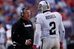EAST RUTHERFORD, NJ - OCTOBER 11:  Head Coach Tom Cable and JaMarcus Russell #2 of the Oakland Raiders talk in between plays during the game on October 11, 2009 at Giants Stadium in East Rutherford, New Jersey.  (Photo by Jared Wickerham/Getty Images)