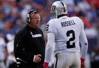 EAST RUTHERFORD, NJ - OCTOBER 11:  Head Coach Tom Cable and JaMarcus Russell #2 of the Oakland Raiders talk in between plays during the game on October 11, 2009 at Giants Stadium in East Rutherford, New Jersey.  (Photo by Jared Wickerham/Getty Images)
