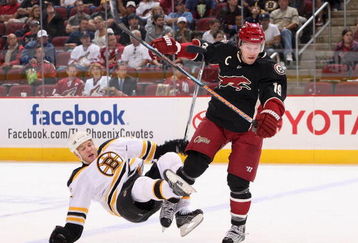 GLENDALE, AZ - OCTOBER 17:  Shane Doan #19 of the Phoenix Coyotes lays a body check onto Shawn Thornton #22 of the Boston Bruins during the NHL game at Jobing.com Arena on October 17, 2009 in Glendale, Arizona. The Coyotes defeated the Bruins 4-1.  (Photo by Christian Petersen/Getty Images)