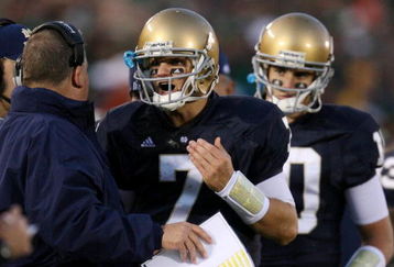 SOUTH BEND, IN - OCTOBER 17: Head coach Charlie Weis of the Notre Dame Fighting Irish speaks to quarterback Jimmy Clausen #7 during the fourth quarter against the USC Trojans at Notre Dame Stadium on October 17, 2009 in South Bend, Indiana. USC won the game 34-27. (Photo by Jonathan Daniel/Getty Images)