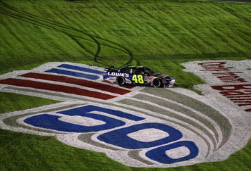 CONCORD, NC - OCTOBER 17:  Jimmie Johnson, driver of the #48 Lowe's Chevrolet, slides through the grass as he celebrates after winning the NASCAR Sprint Cup Series NASCAR Banking 500 at Lowe's Motor Speedway on October 17, 2009 in Concord, North Carolina.  (Photo by Streeter Lecka/Getty Images)