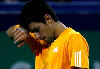 SHANGHAI, CHINA - OCTOBER 17:  Novak Djokovic of Serbia wipes his forehead between points against Nikolay Davydenko of Russia during the semifinal round on day seven of the 2009 Shanghai ATP Masters 1000 at Qi Zhong Tennis Centre on October 17, 2009 in Shanghai, China.  (Photo by Matthew Stockman/Getty Images)