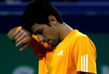 SHANGHAI, CHINA - OCTOBER 17:  Novak Djokovic of Serbia wipes his forehead between points against Nikolay Davydenko of Russia during the semifinal round on day seven of the 2009 Shanghai ATP Masters 1000 at Qi Zhong Tennis Centre on October 17, 2009 in Shanghai, China.  (Photo by Matthew Stockman/Getty Images)