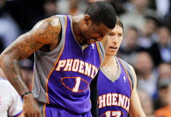 LOS ANGELES, CA - FEBRUARY 18:  Amar'e Stoudamire #1 of the Phoenix Suns is comforted by teammate Steve Nash #13 after a collision with Al Thornton #12 of the Los Angeles Clippers during the first half action against at the Staples Center February 18, 2009, in Los Angeles, California. The Suns have announced that Amare Stoudemire was forced to undergo surgery Friday to repair a partially detached retina in his right eye suffered in a Wednesday night rout of the Los Angeles Clippers. It is Stoudemire's second injury in that eye since October and threatens to sideline the All-Star forward for the rest of the regular season.NOTE TO USER: User expressly acknowledges and agrees that, by downloading and or using this photograph, User is consenting to the terms and conditions of the Getty Images License Agreement.  (Photo by Kevork Djansezian/Getty Images)