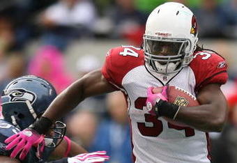 SEATTLE - OCTOBER 18: Running back Tim Hightower #34 of the Arizona Cardinals rushes against Darryl Tapp #55 of the Seattle Seahawks on October 18, 2009 at Qwest Field in Seattle, Washington. (Photo by Otto Greule Jr/Getty Images)