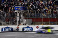 CONCORD, NC - OCTOBER 17: Jimmie Johnson, driver of the #48 Lowe's Chevrolet, crosses the finish line to win the NASCAR Sprint Cup Series NASCAR Banking 500 at Lowe's Motor Speedway on October 17, 2009 in Concord, North Carolina. (Photo by Geoff Burke/Getty Images for NASCAR)