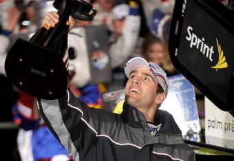 CONCORD, NC - OCTOBER 17:  Jimmie Johnson, driver of the #48 Lowe's Chevrolet, holds up the trophy after winning the NASCAR Sprint Cup Series NASCAR Banking 500 at Lowe's Motor Speedway on October 17, 2009 in Concord, North Carolina.  (Photo by Rusty Jarrett/Getty Images for NASCAR)