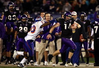 SAN DIEGO, CA - DECEMBER 23:  Quarterback Andy Dalton #14 of  TCU runs with the ball against the tackle of Safety Jeron Johnson #23 of Boise State during the San Diego County Credit Union Poinsettia Bowl at Qualcomm Stadium on December 23, 2008 in San Diego, California. (Photo by Donald Miralle/Getty Images)