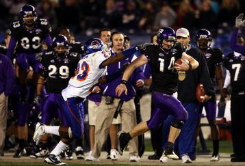 SAN DIEGO, CA - DECEMBER 23:  Quarterback Andy Dalton #14 of  TCU runs with the ball against the tackle of Safety Jeron Johnson #23 of Boise State during the San Diego County Credit Union Poinsettia Bowl at Qualcomm Stadium on December 23, 2008 in San Diego, California. (Photo by Donald Miralle/Getty Images)