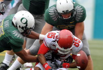 EUGENE, OR - SEPTEMBER 19: Jereme Brooks #85 of the Utah Utes fumbles the ball as Kenny Rowe #58, Blake Ferras #90 and Casey Matthews #55 of the Oregon Ducks close in during the first quarter at Autzen Stadium on September 19, 2009 in Eugene, Oregon. Oregon won the game 31-24. (Photo by Steve Dykes/Getty Images)