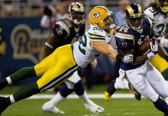ST. LOUIS, MO - SEPTEMBER 27: Clay Matthews #52 of the Green Bay Packers tackles Keenan Burton #14 of the St. Louis Rams at the Edward Jones Dome on September 27, 2009 in St. Louis, Missouri.  The Packers beat the Rams 36-17.  (Photo by Dilip Vishwanat/Getty Images)